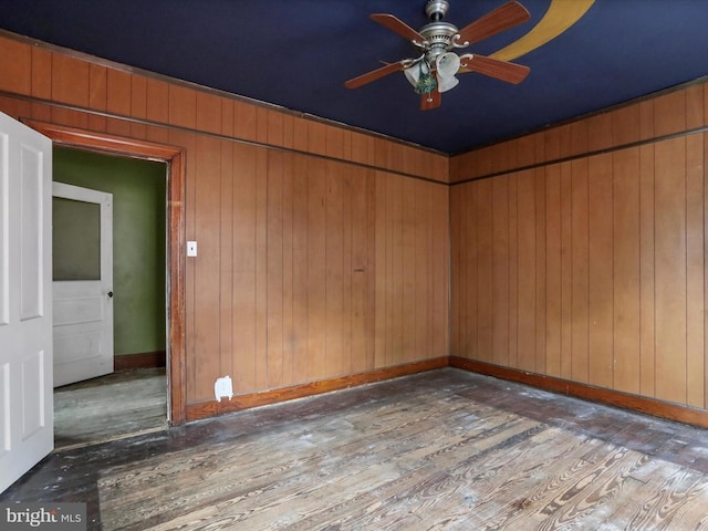 16 Avalon Ave, Hagerstown, MD 21740 - spare room featuring hardwood / wood-style floors, a ceiling fan, baseboards, and wood walls