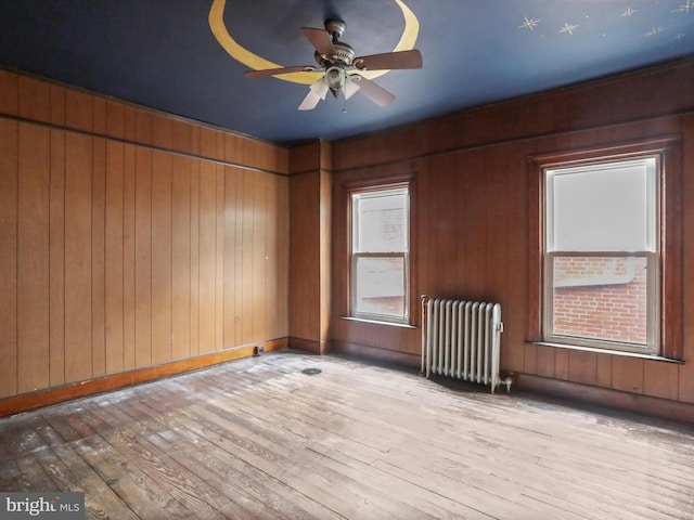 16 Avalon Ave, Hagerstown, MD 21740 - unfurnished room with radiator, light wood finished floors, a ceiling fan, and wooden walls