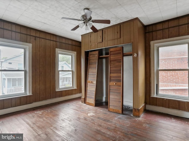 16 Avalon Ave, Hagerstown, MD 21740 - unfurnished bedroom featuring hardwood / wood-style flooring, a closet, wood walls, and a ceiling fan
