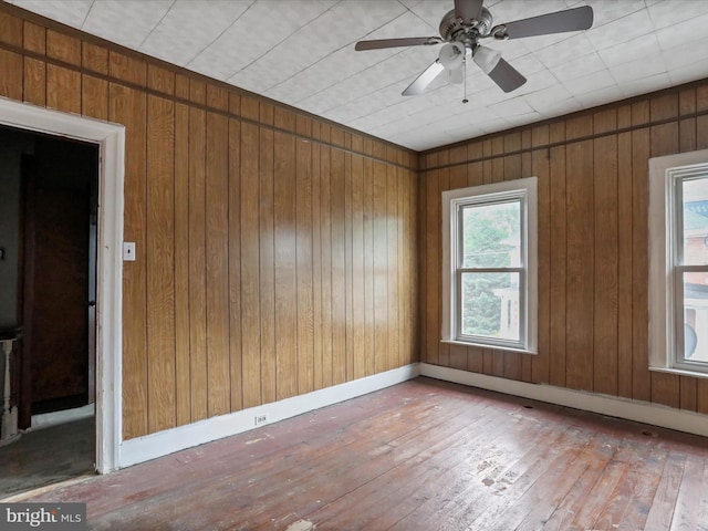 16 Avalon Ave, Hagerstown, MD 21740 - empty room with wood-type flooring, wooden walls, and a ceiling fan