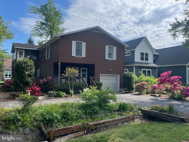 8 Grand Port Rd, Ocean Pines, MD 21811 - view of front of home with driveway, a garage, a porch, and board and batten siding