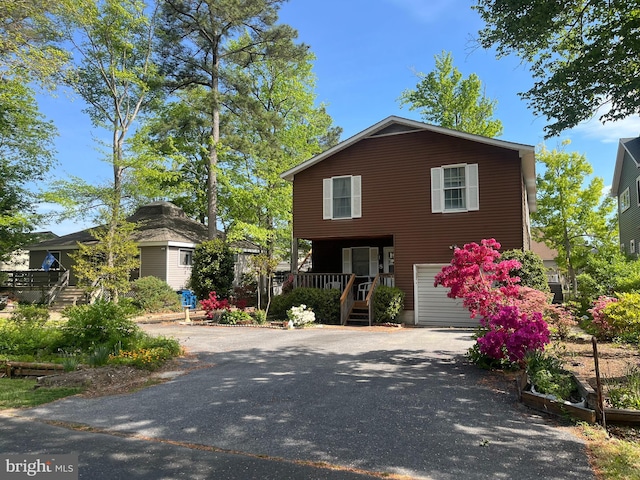 8 Grand Port Rd, Ocean Pines, MD 21811 - view of front of home featuring an attached garage, driveway, and a porch