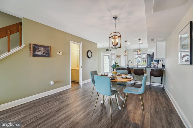 15 Queen Anne Way Unit E, Chester, MD 21619 - dining space featuring dark wood finished floors, baseboards, and a chandelier