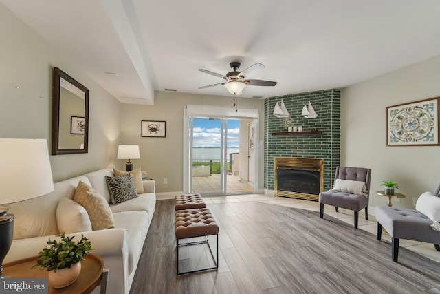 15 Queen Anne Way Unit E, Chester, MD 21619 - living area with ceiling fan, wood finished floors, a fireplace, and baseboards