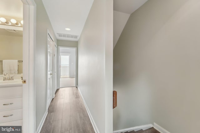 15 Queen Anne Way Unit E, Chester, MD 21619 - hall with baseboards, light wood-type flooring, and a sink
