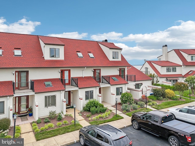 15 Queen Anne Way Unit E, Chester, MD 21619 - view of property featuring uncovered parking, stucco siding, and a balcony