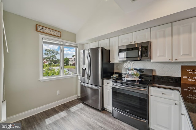 15 Queen Anne Way Unit E, Chester, MD 21619 - kitchen featuring stainless steel appliances, white cabinetry, decorative backsplash, light wood-style flooring, and baseboards
