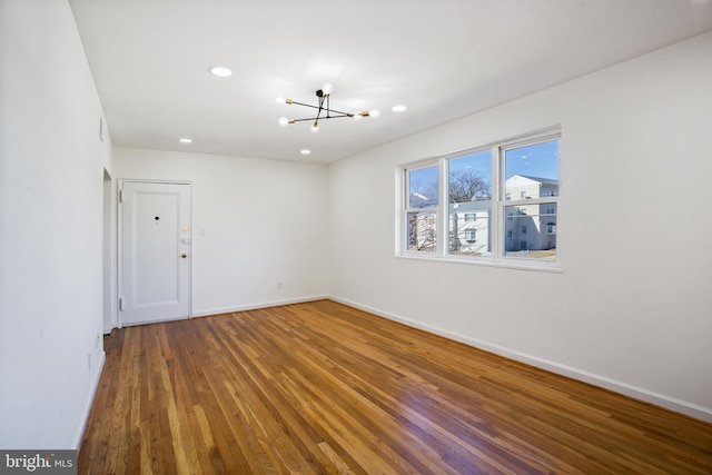 3059 Patrick Henry Dr Unit 201, Falls Church, VA 22044 - spare room with a chandelier, wood finished floors, baseboards, and recessed lighting