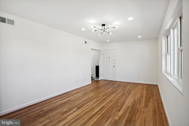 3059 Patrick Henry Dr Unit 201, Falls Church, VA 22044 - unfurnished room with a chandelier, wood finished floors, baseboards, and recessed lighting
