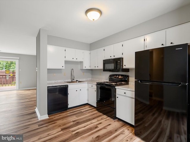 237 Kimberly Way, Winchester, VA 22601 - kitchen featuring black appliances, a sink, light wood-style floors, and white cabinetry