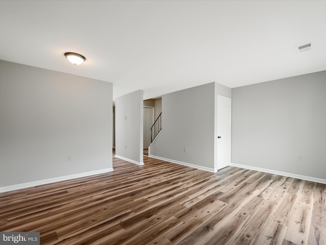 237 Kimberly Way, Winchester, VA 22601 - spare room featuring wood finished floors, baseboards, and stairway