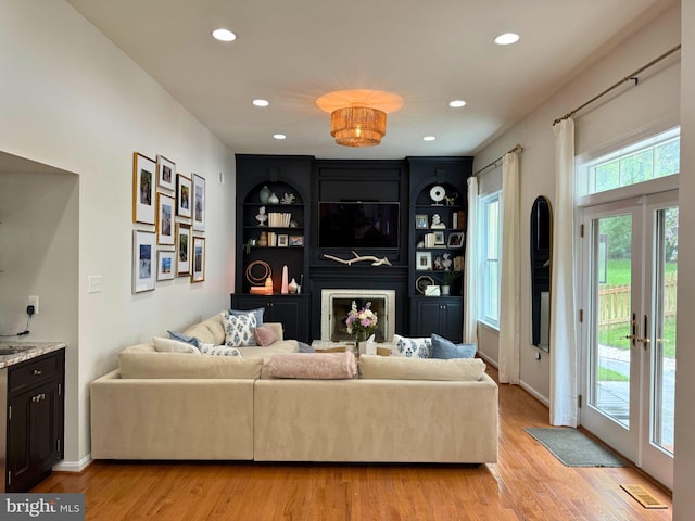 10000 Manor Pl, Fairfax, VA 22032 - living room with light wood finished floors, recessed lighting, a large fireplace, and baseboards