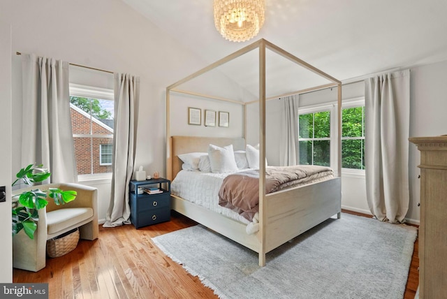 10000 Manor Pl, Fairfax, VA 22032 - bedroom with multiple windows, a chandelier, wood finished floors, and vaulted ceiling