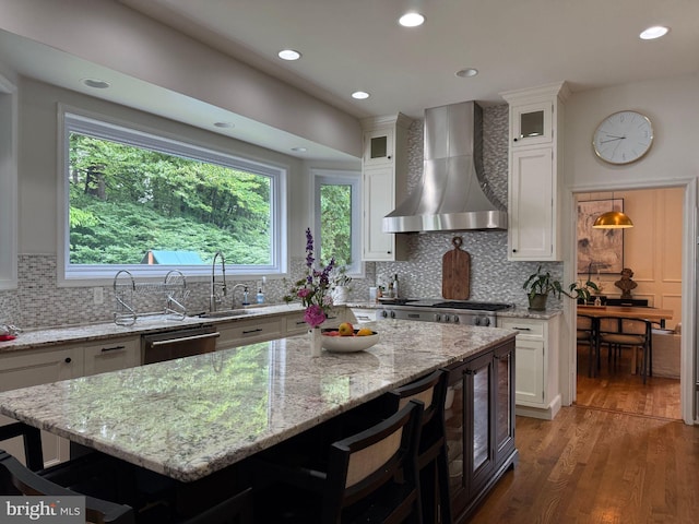 10000 Manor Pl, Fairfax, VA 22032 - kitchen featuring wall chimney exhaust hood, dishwasher, a kitchen bar, white cabinets, and recessed lighting