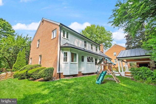 10000 Manor Pl, Fairfax, VA 22032 - back of house featuring a playground, brick siding, and a chimney