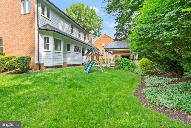10000 Manor Pl, Fairfax, VA 22032 - rear view of house with a playground and a lawn
