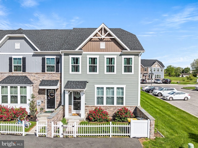 8 Ryan Ct, Gilbertsville, PA 19525 - view of front of house with stone siding, a fenced front yard, and a shingled roof
