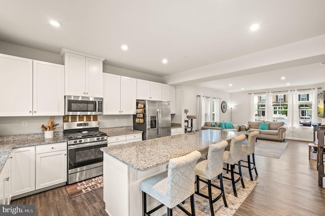 8 Ryan Ct, Gilbertsville, PA 19525 - kitchen featuring stainless steel appliances, open floor plan, a kitchen island, recessed lighting, and light stone countertops