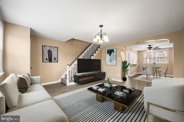 4528 Tudor St, Philadelphia, PA 19136 - living area featuring arched walkways, wood finished floors, stairway, and baseboards