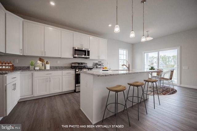 1019 Robinson Rd, Townsend, DE 19734 - kitchen featuring appliances with stainless steel finishes, dark wood-type flooring, a sink, white cabinetry, and a breakfast bar