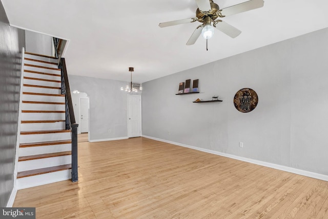1936 S Sartain St, Philadelphia, PA 19148 - unfurnished living room featuring light wood-style floors, stairs, baseboards, and a chandelier