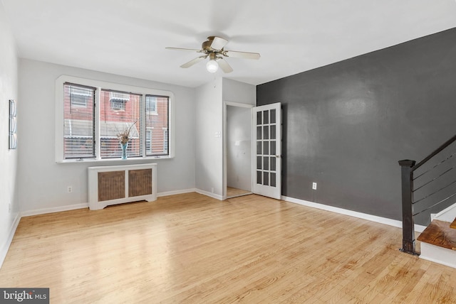 1936 S Sartain St, Philadelphia, PA 19148 - spare room with radiator heating unit, ceiling fan, wood finished floors, stairway, and baseboards