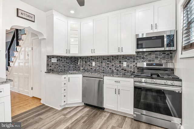 1936 S Sartain St, Philadelphia, PA 19148 - kitchen with stainless steel appliances, stone counters, a sink, light wood-type flooring, and white cabinets