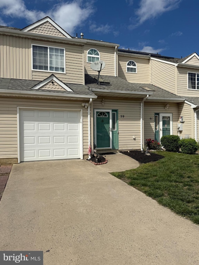 59 Sassafras Dr, Lumberton, NJ 08060 - townhome / multi-family property featuring a garage, concrete driveway, a front yard, and board and batten siding