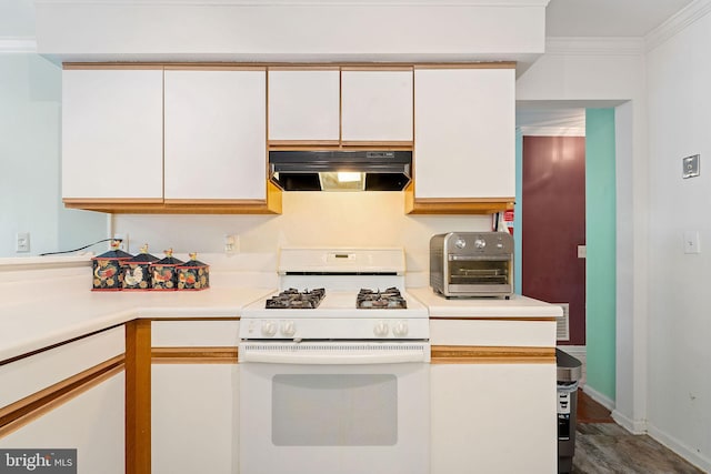 59 Sassafras Dr, Lumberton, NJ 08060 - kitchen featuring white gas stove, under cabinet range hood, light countertops, white cabinetry, and baseboards