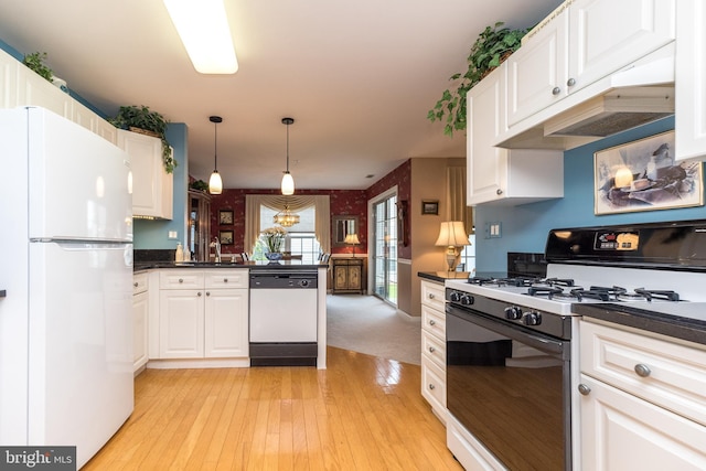 205 Strawberry Ct, Warwick, PA 18974 - kitchen featuring white appliances, dark countertops, a peninsula, a sink, and white cabinetry