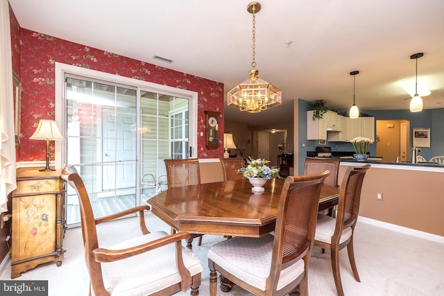 205 Strawberry Ct, Warwick, PA 18974 - dining room with wallpapered walls, a chandelier, light colored carpet, and baseboards