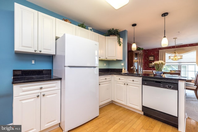 205 Strawberry Ct, Warwick, PA 18974 - kitchen with white appliances, light wood-style flooring, a sink, white cabinets, and a peninsula
