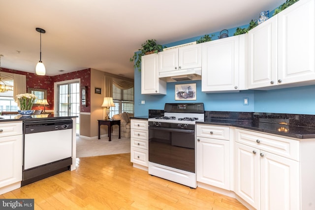 205 Strawberry Ct, Warwick, PA 18974 - kitchen featuring white dishwasher, gas stove, dark countertops, under cabinet range hood, and light wood-style flooring