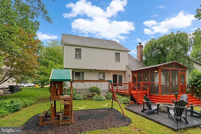 260 Whistling Pine Rd, Severna Park, MD 21146 - back of property featuring a fire pit, a sunroom, a patio, a playground, and central air condition unit