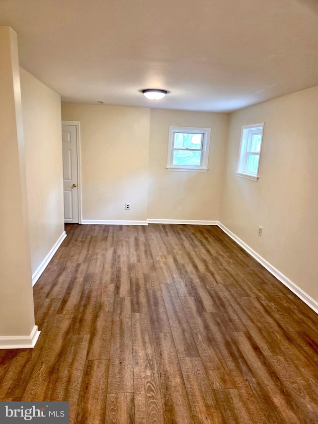 2404 Woodlea Dr, Joppa, MD 21085 - unfurnished room featuring dark wood-style flooring and baseboards