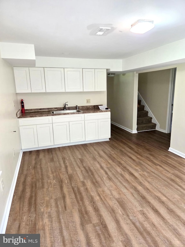 2404 Woodlea Dr, Joppa, MD 21085 - kitchen with a sink, wood finished floors, white cabinets, and baseboards