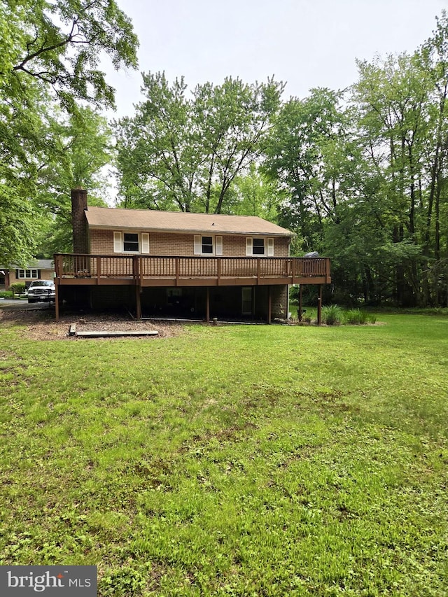 2404 Woodlea Dr, Joppa, MD 21085 - back of property with a wooden deck, a lawn, and a chimney