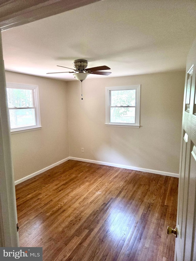 2404 Woodlea Dr, Joppa, MD 21085 - empty room featuring plenty of natural light, wood finished floors, baseboards, and ceiling fan