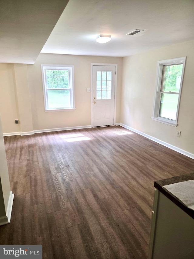 2404 Woodlea Dr, Joppa, MD 21085 - unfurnished living room with dark wood-style flooring and baseboards