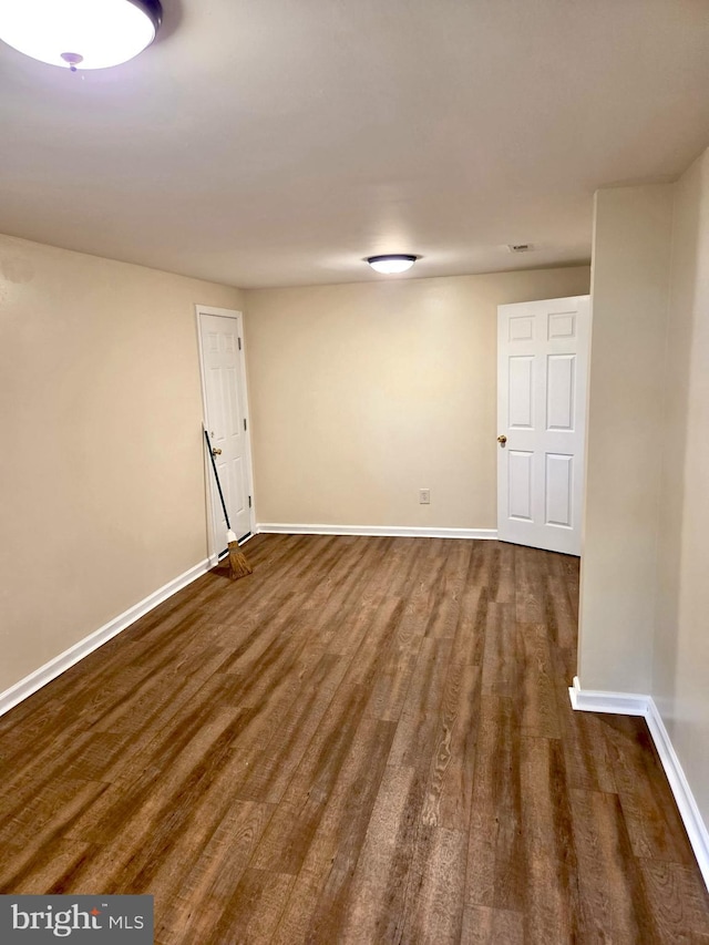 2404 Woodlea Dr, Joppa, MD 21085 - spare room featuring baseboards and dark wood finished floors