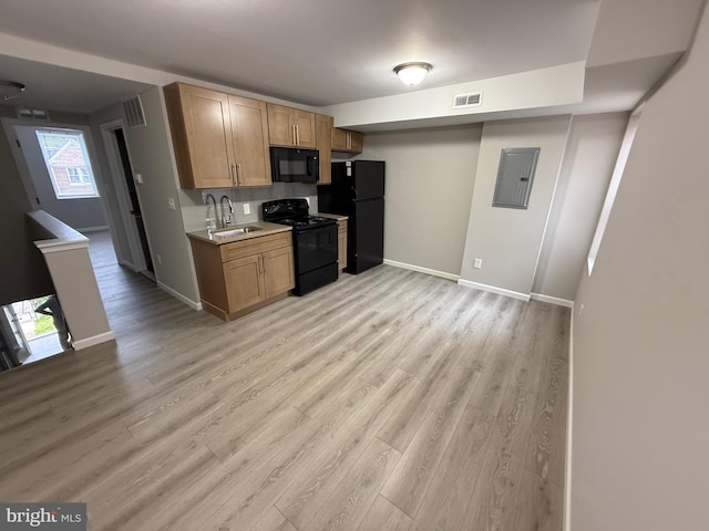 1727 Dallas St, Philadelphia, PA 19126 - kitchen with black appliances, a sink, light countertops, baseboards, and light wood finished floors