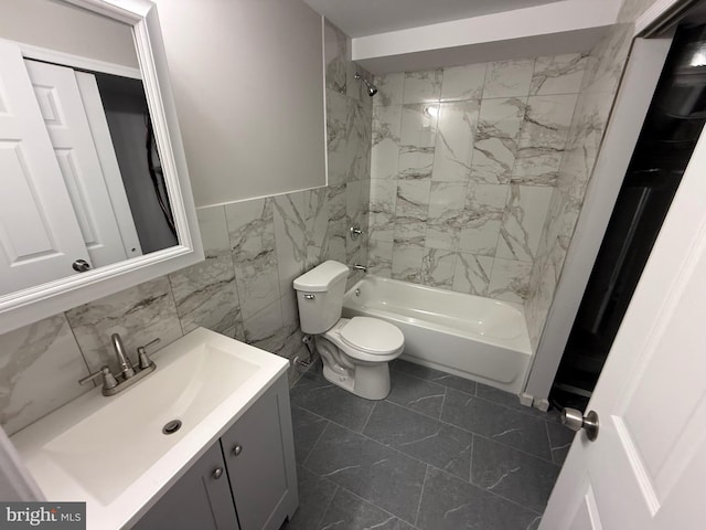 1727 Dallas St, Philadelphia, PA 19126 - full bathroom with  shower combination, vanity, toilet, tile walls, and a wainscoted wall