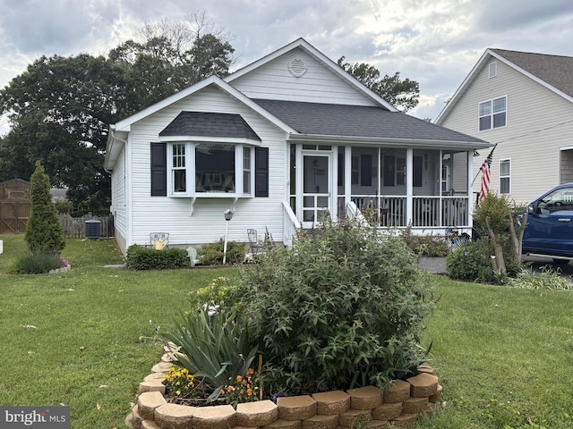 527 Monroe Bay Ave, Colonial Beach, VA 22443 - back of property featuring roof with shingles, a sunroom, a yard, and cooling unit