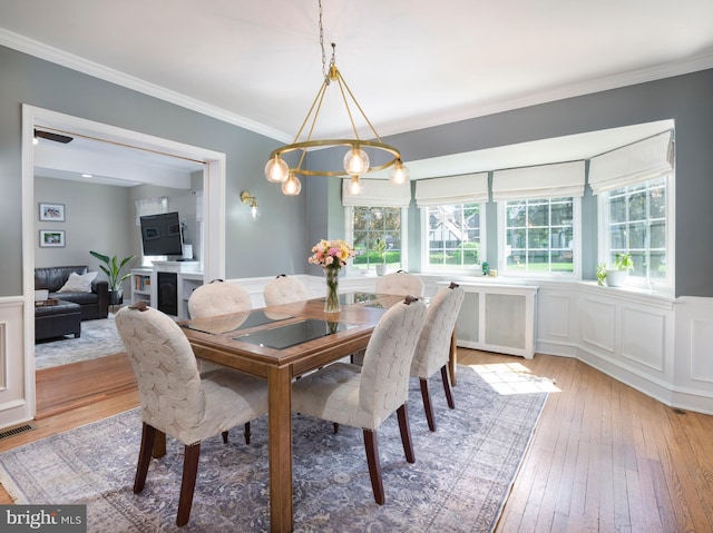 1204 Drexel Ave, Drexel Hill, PA 19026 - dining room with light wood-type flooring, wainscoting, ornamental molding, and a decorative wall