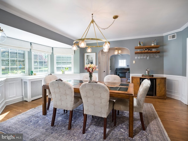 1204 Drexel Ave, Drexel Hill, PA 19026 - dining area with arched walkways, wood finished floors, a decorative wall, crown molding, and a wainscoted wall