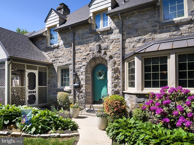 1204 Drexel Ave, Drexel Hill, PA 19026 - entrance to property with stone siding, a chimney, and a standing seam roof