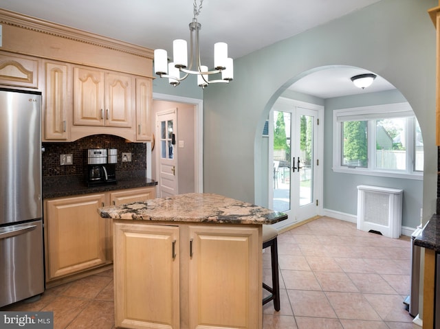 1204 Drexel Ave, Drexel Hill, PA 19026 - kitchen with freestanding refrigerator, radiator, arched walkways, light brown cabinets, and tasteful backsplash