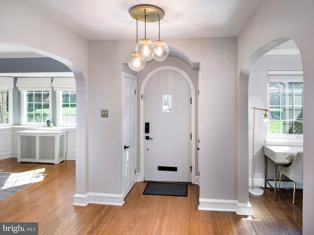 1204 Drexel Ave, Drexel Hill, PA 19026 - foyer with light wood-type flooring, arched walkways, plenty of natural light, and baseboards