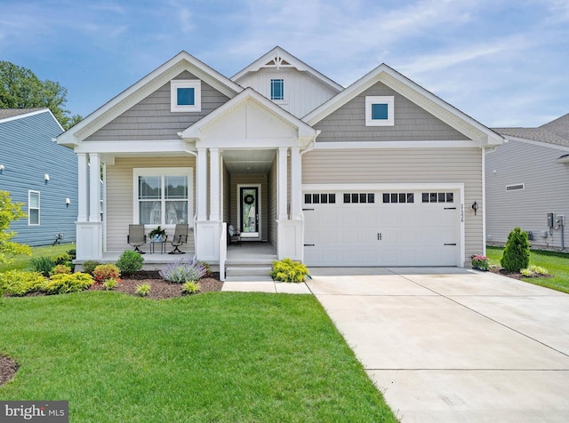 21336 Dauphine St, Lewes, DE 19958 - craftsman-style home with a porch, a garage, concrete driveway, and a front yard