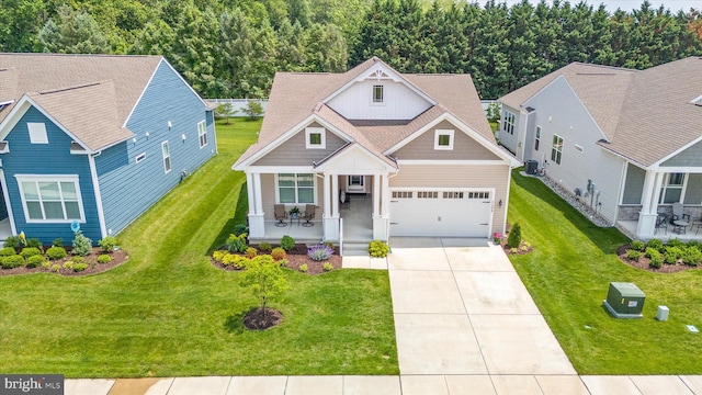 21336 Dauphine St, Lewes, DE 19958 - craftsman inspired home with a porch, concrete driveway, a front yard, board and batten siding, and an attached garage